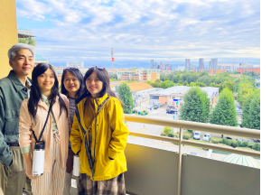 four people on a balcony