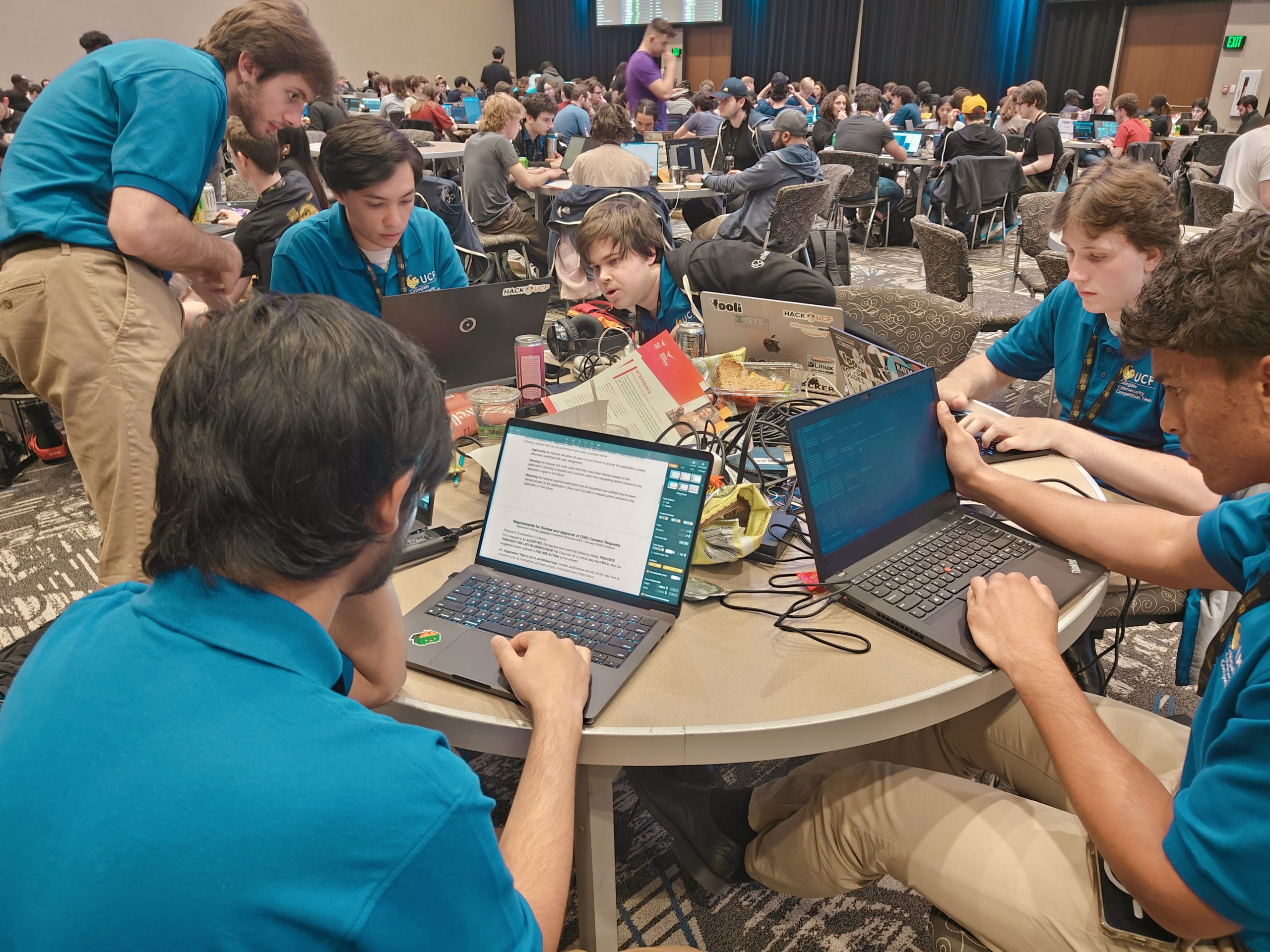 students working at a table wth laptops